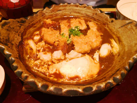 Curry  pig in a hotpot with soft boiled eggの写真素材
