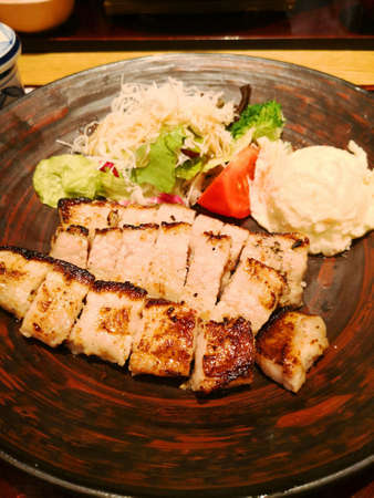 Grilled belly pork with potatoes saladの写真素材
