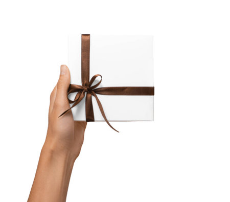 Isolated Woman Hands holding Holiday Present White Box with Brown Ribbon on a White Backgroundの写真素材
