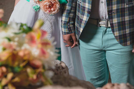 Wedding photo shoot in the castle. Loving couple hold hands in a romantic setting. Beautiful wedding...