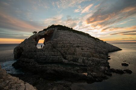 Sunset over the rocks at korakonisi zakynthosの写真素材