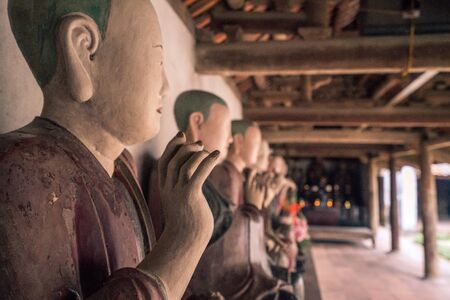 a row of buddah statues in vietnam