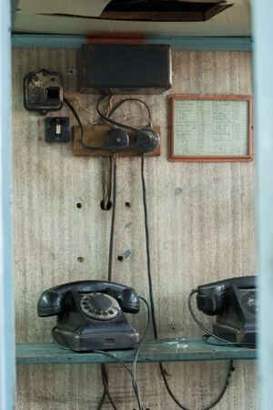 old telephones with dialng disks on the wooden tableの写真素材