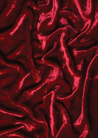Background made of wrinkled burgundy shiny velvetの写真素材