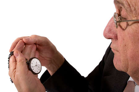 An old man is looking at the watchの写真素材