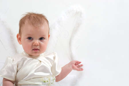 cute little girl dressed like fairy with fluffy wings is cryingの写真素材