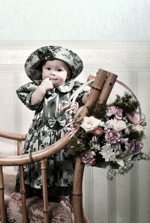 Victorian style portrait of cute little girl dressed in the formal wear. Copy space on the topの写真素材