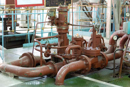 Old rusty pipes and valves with water leaks