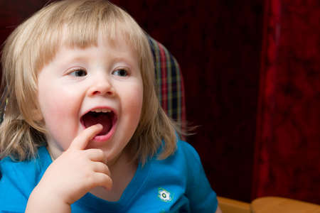 cute little girl with finger in her mouth