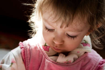 portrait of cute little girl in the rays of sunの写真素材