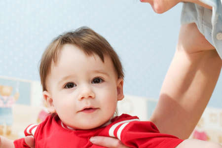 portrait of cute little baby in mother's hands