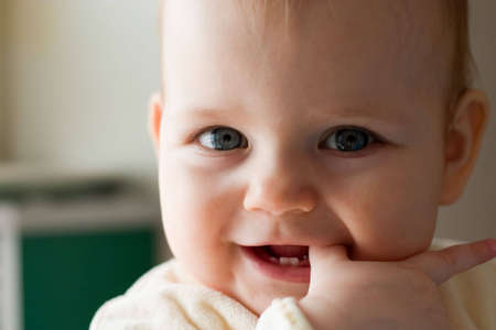 cute little girl in the light of sunの写真素材