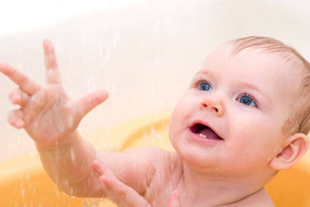 happy cute little baby girl taking shower
