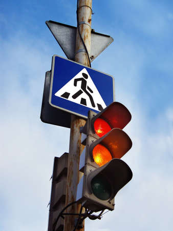 traffic light and road sign on the old rusty post  