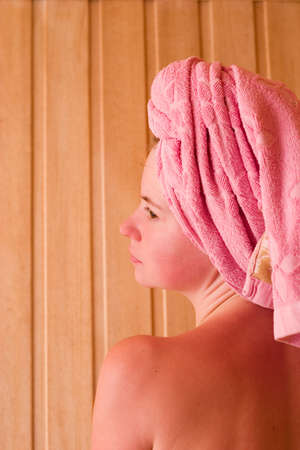beautiful young woman is relaxing in saunaの写真素材