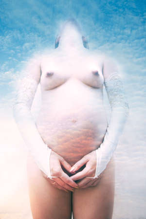 Beautiful pregnant woman's body, symbolize mother-nature and maternity. Special photo f/x.の写真素材