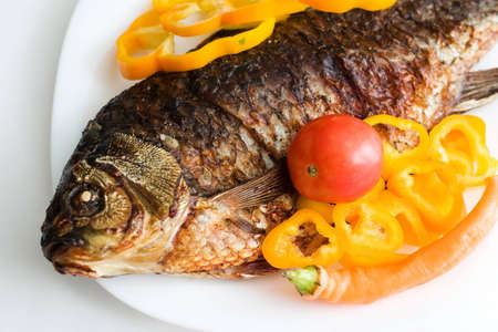 grilled carp garnished with paprika and tomato