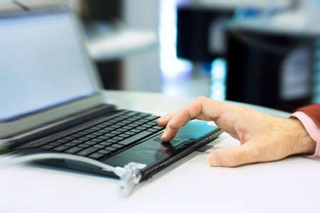 Man working at the laptop. Low DOF, motion blur photo f/x