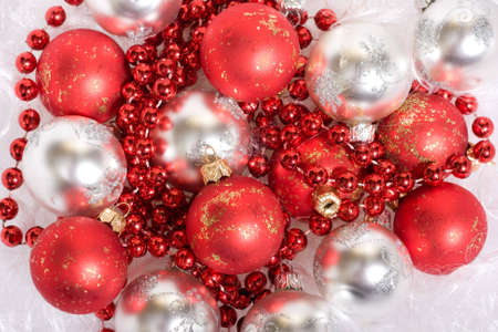 White and red christmas balls and red beads, on Santa's beardの写真素材