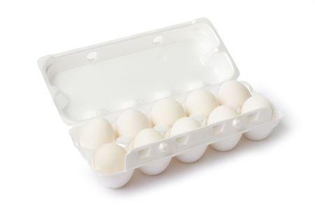 Eggs on egg lifting tray, on white backgroundの写真素材