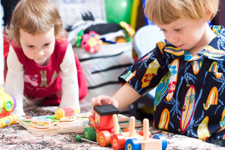 Cute children playing in kindergarten with colorful toysの写真素材