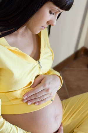 Pregnant woman having rest. Focus on faceの写真素材