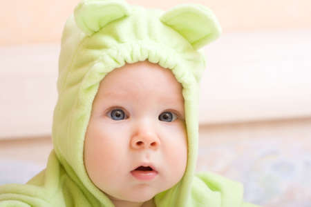 Cute five month baby in green jumpers の写真素材