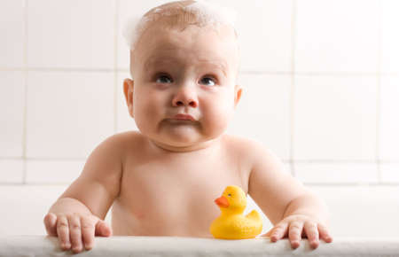 happy cute little baby boy taking bath
