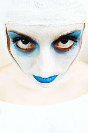 spooky female clown in heavy stage make-upの写真素材