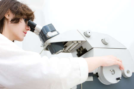 Young woman scientist working with microtome