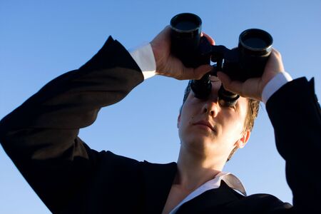 Man with binocular, focus on faceの写真素材