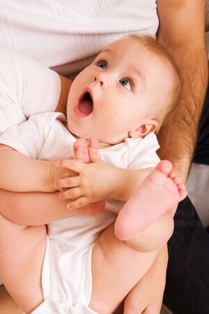 cute little baby girl in parent's hands