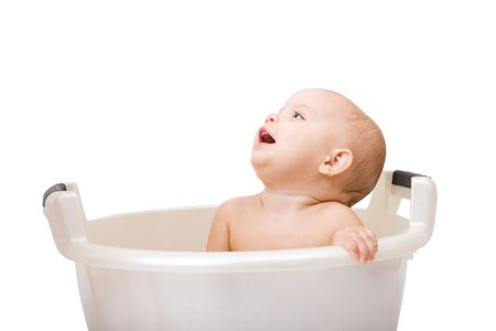 Cute baby having bath in white tubの写真素材