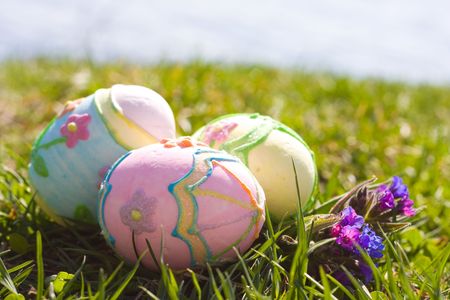 Three colored easter eggs in the green grass
