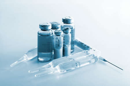 Flasks with medicines and syringe. Blue tone special FXの写真素材