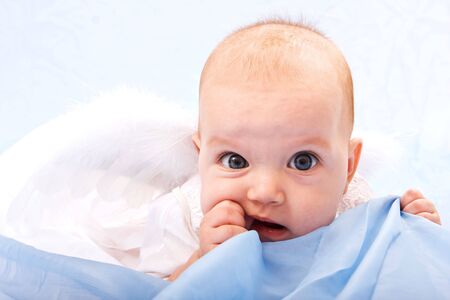 Close-up portrait of little cute girl in white dressの写真素材