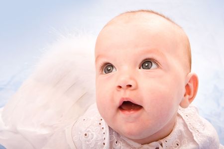 Close-up portrait of little cute girl in white dressの写真素材