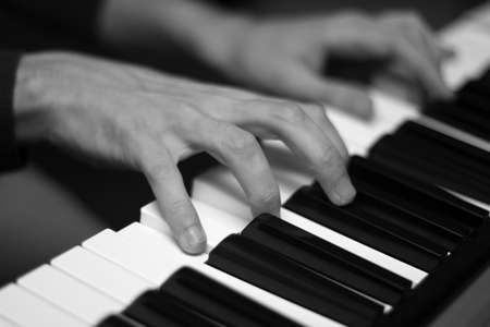 Hands of musician playing piano. Low DOFの写真素材