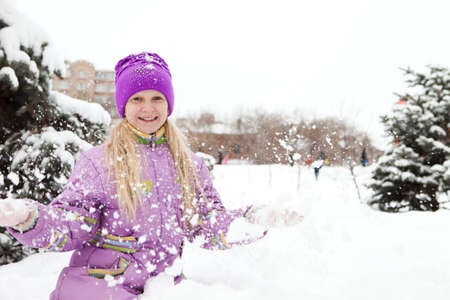 Young and cute girl enjoying fresh snowの写真素材