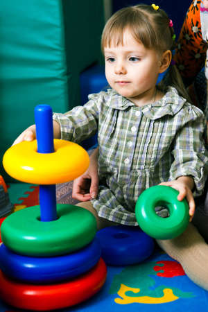 Portrait of cute little girl playing toysの写真素材