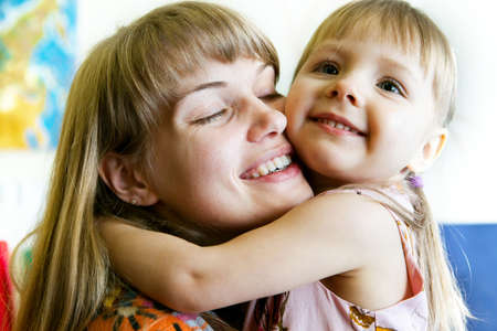 Portrait of cute little girl and her young motherの写真素材