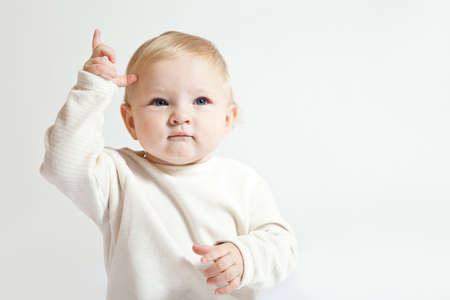 Portrait of cute little girl in white clothesの写真素材