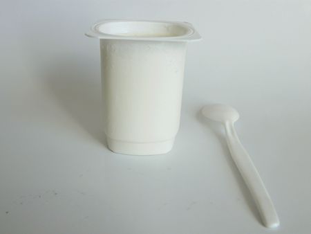A close up of a Yoghurt and a spoonの写真素材
