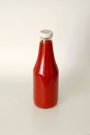 A close up view of a bottle of ketchup over whiteの写真素材