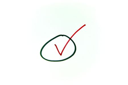 A close up view of a check mark in a circle over whiteの写真素材