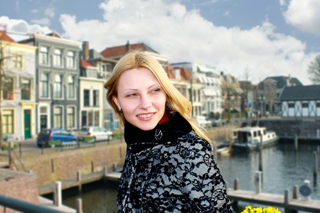 Girl on the waterfront in the Dutch town of Gorinchem. Netherlandsの写真素材