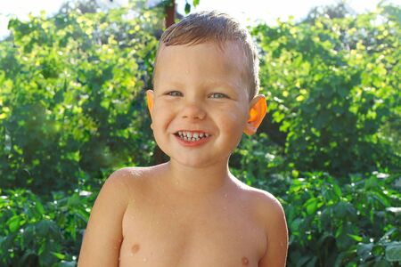 Joyful baby after bathing in the gardenの写真素材