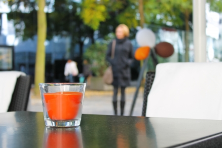 The candle on the table in the autumn cafeの写真素材