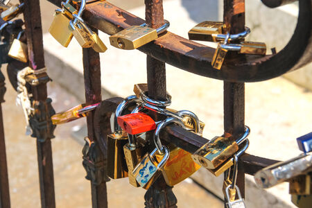 FLORENCE, ITALY - MAY 08, 2014: Padlocks on the fence of bridge in Florence, symbolizing eternal...