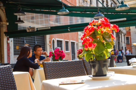VENICE, ITALY - MAY 06, 2014: Tourists rest in an outdoor cafe,Venice, Italyのeditorial素材